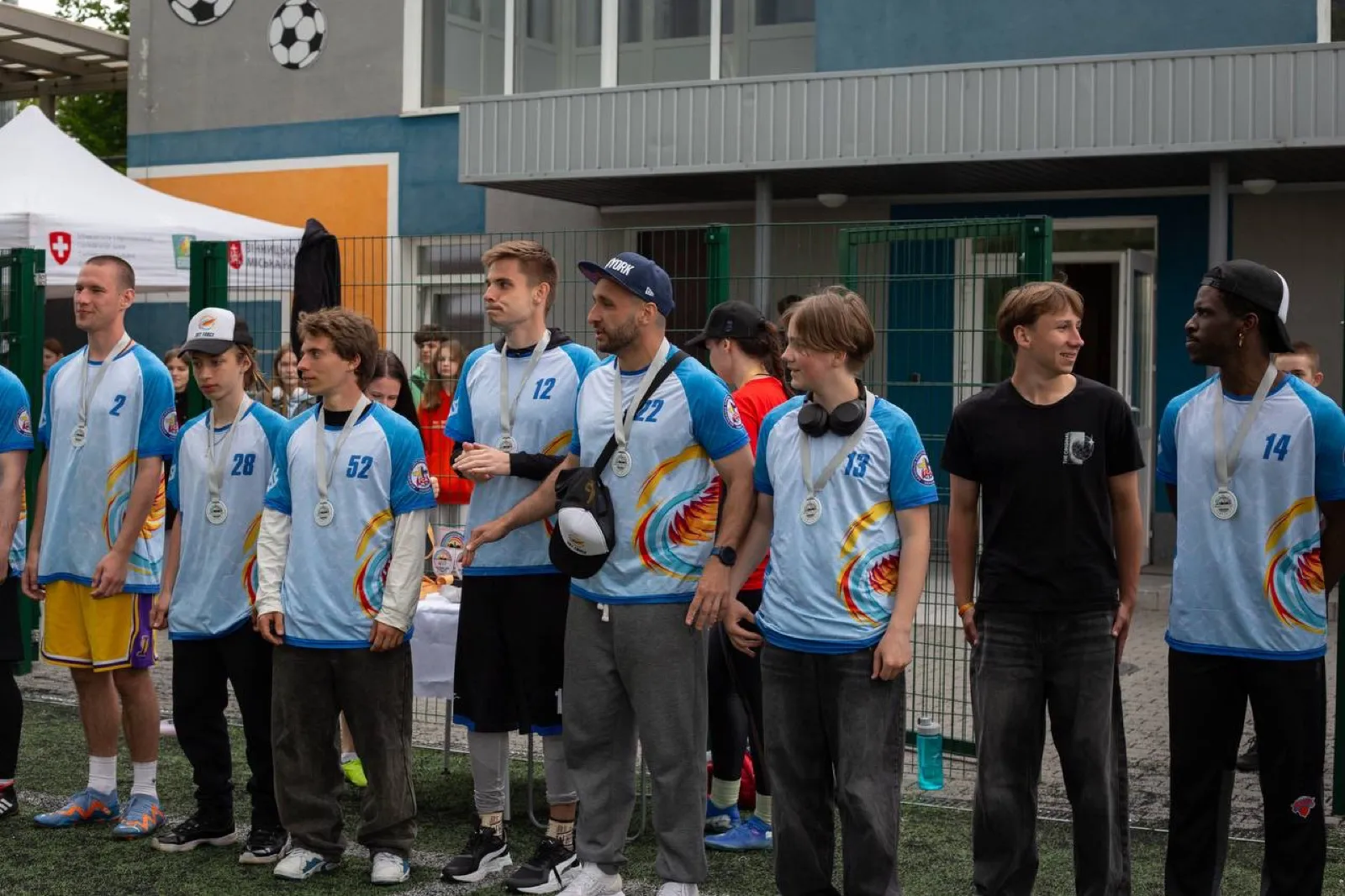 Boys lined up at an outdoor closing ceremony.