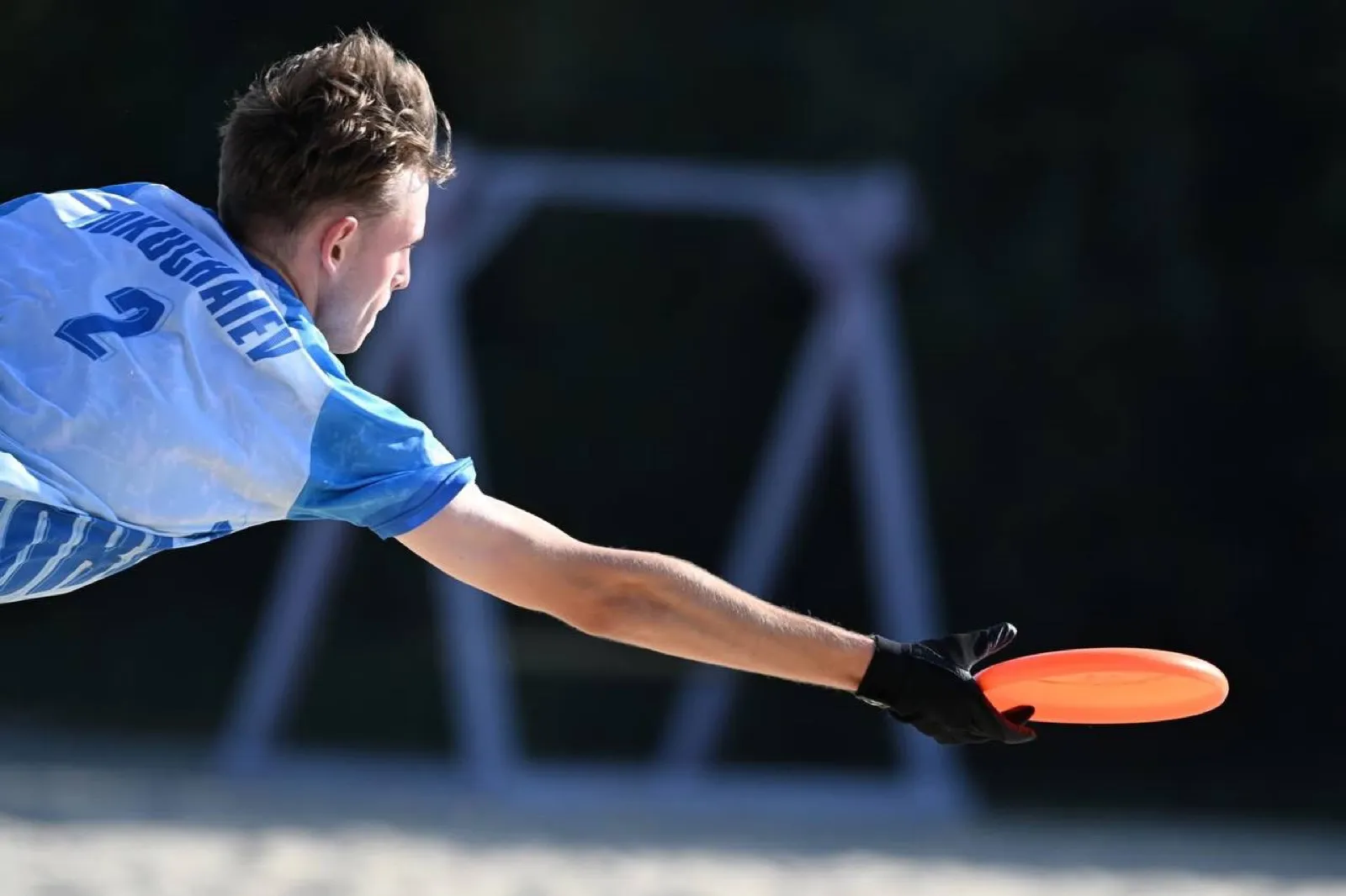 A diving catch with an orange disc.