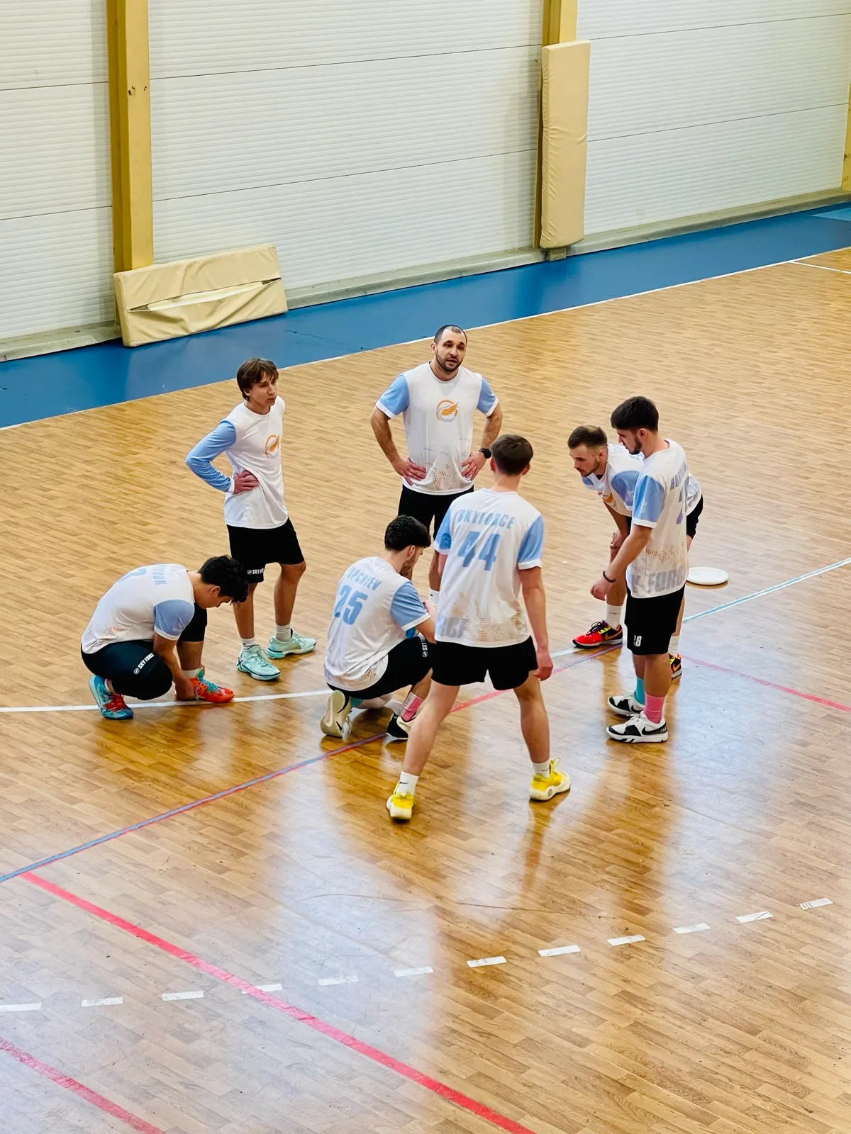 Players huddle around the coach.