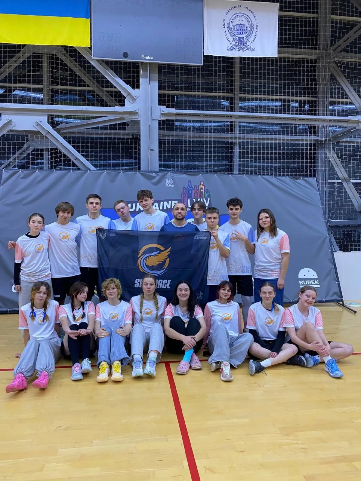 Kids team with the SkyForce banner.