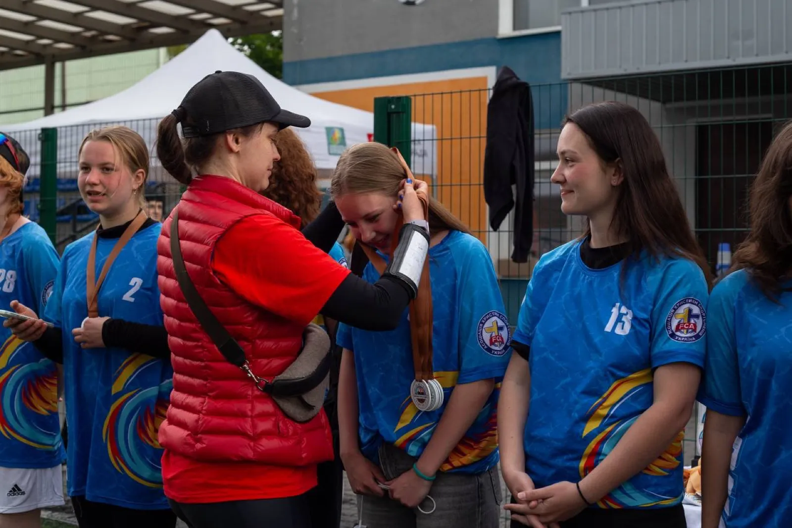 A girl receives a medal at a ceremony.